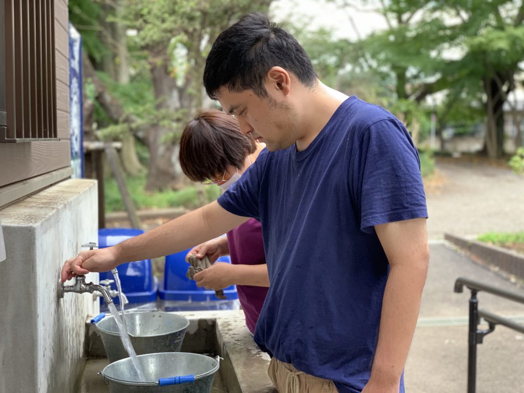 バケツに水をそそぐ利用者